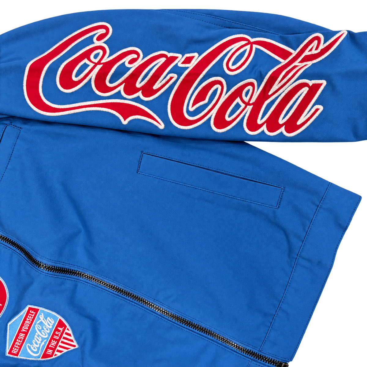 PREME blue Coca-Cola jacket embroidered Coca-Cola sleeve logo close-up