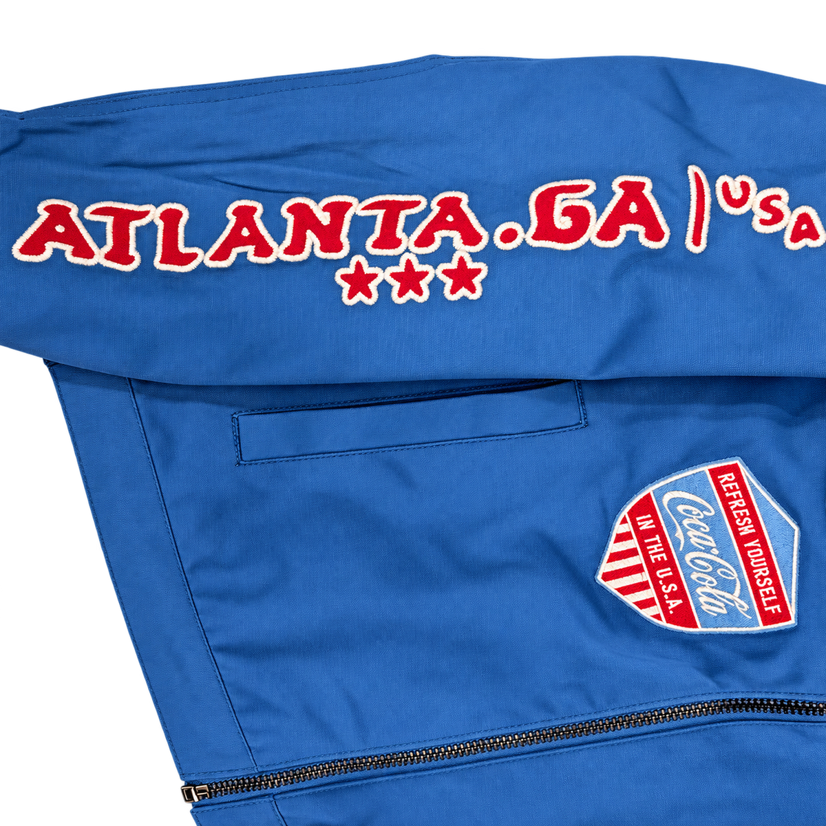 PREME blue Coca-Cola jacket Atlanta sleeve lettering and stars close-up