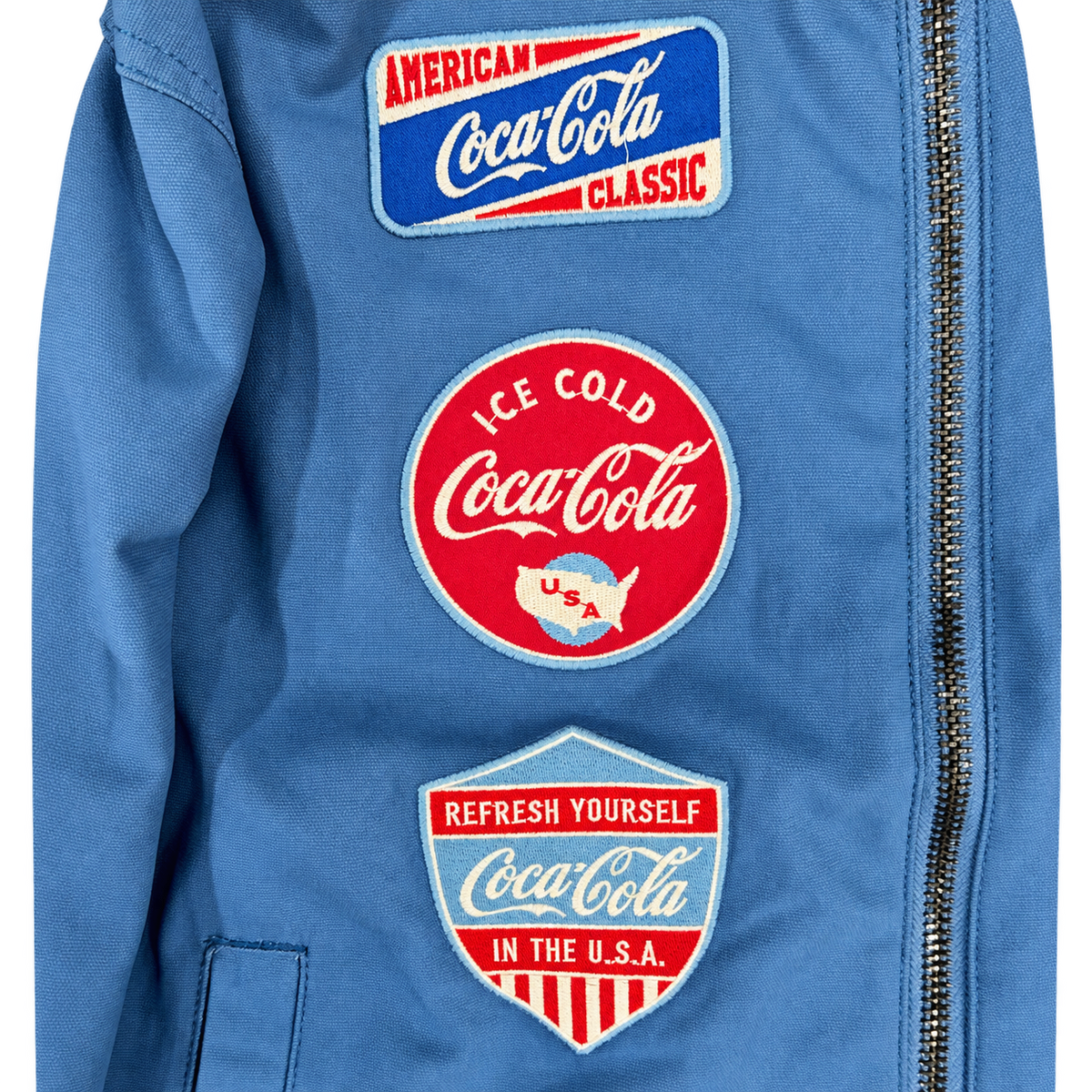 PREME blue Coca-Cola jacket close-up of three front patches